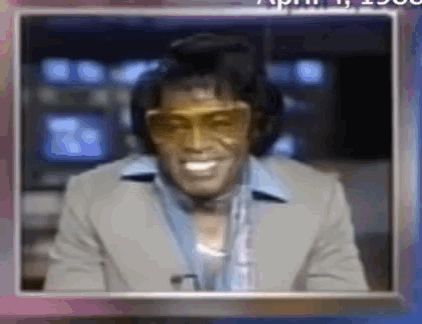 Man in Suit Sunglasses Smiling with Headphones Microphone