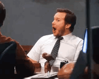 Man in Suit Surprised at Table