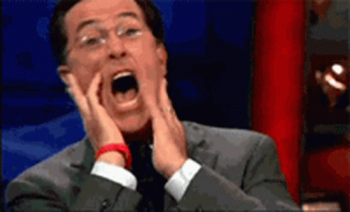 Man in Suit Surprised Hands on Face