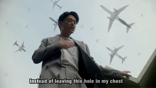 Man In Suit Surrounded By Airplanes Saying Instead Of Leaving This Hole In My Chest GIF
