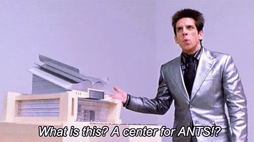 Man in Suit Talking About Ants in Front of Printer