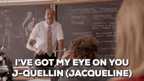 Man in Suit Talking in Classroom