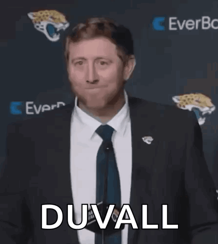 Man In Suit Talking Into Microphone GIF