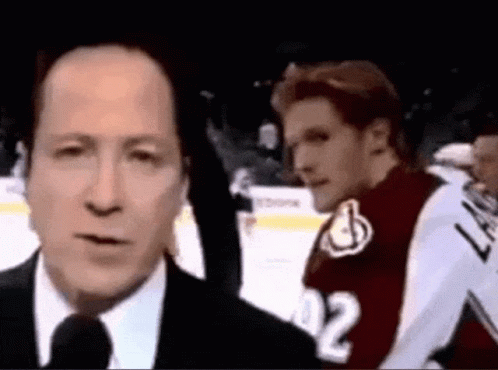 Man In Suit Talking Into Microphone GIF