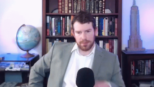 Man In Suit Talking Into Microphone GIF