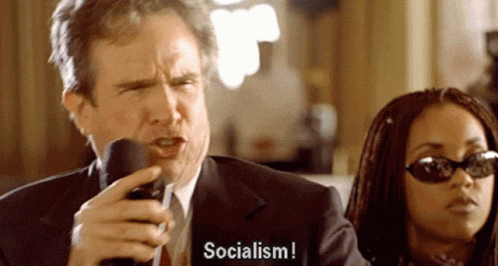 Man In Suit Talking Mic Woman Says Socialism GIF