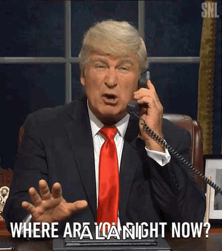 Man in Suit Talking on Phone Saying Where Are You Now