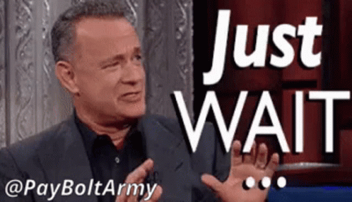 Man in Suit Talking on Talk Show Says Just Wait