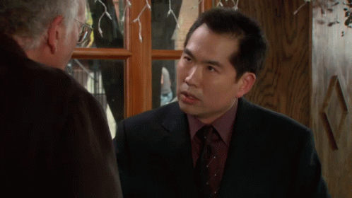 Man in Suit Talking to Another Man