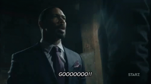 Man In Suit Talking To Another Man In Dark Room GIF