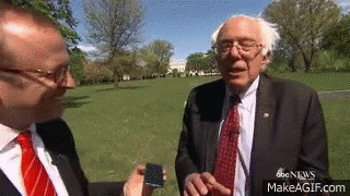 Man in Suit Talking to Another Man in Park