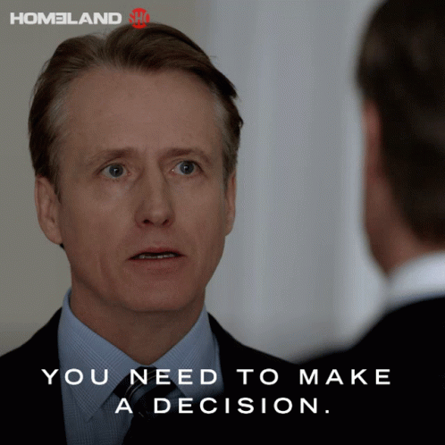 Man in Suit Talking to Another Man Saying You Need to Make a Decision
