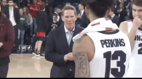 Man in Suit Talking to Basketball Player 13