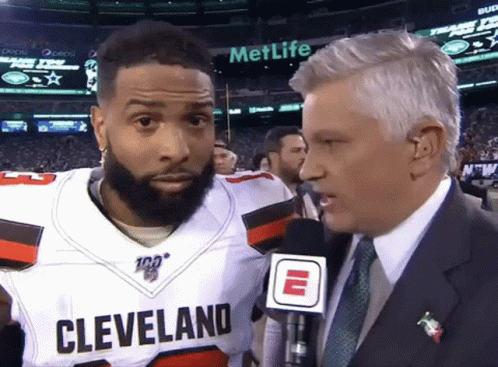Man in Suit Talking to Cleveland Player