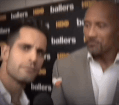 Man in Suit Talking to Man