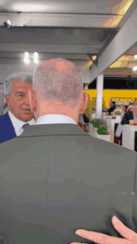 Man In Suit Talking To Man In Blue Suit GIF