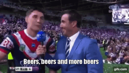 Man in Suit Talking to Man in Red Jersey