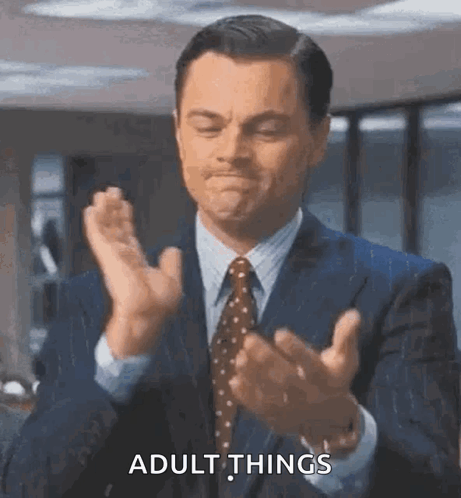 Man In Suit Talking To Man In White Shirt GIF