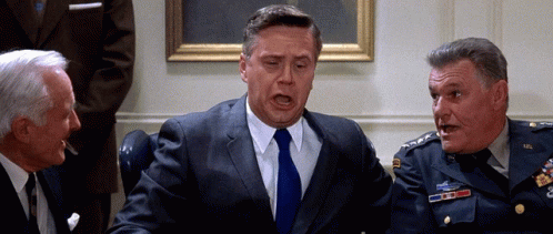 Man In Suit Talking To Two Men GIF