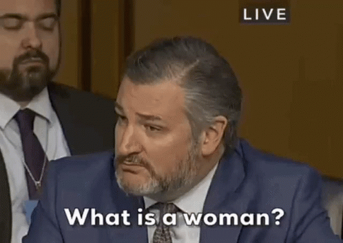 Man in Suit Talking to Woman at Table