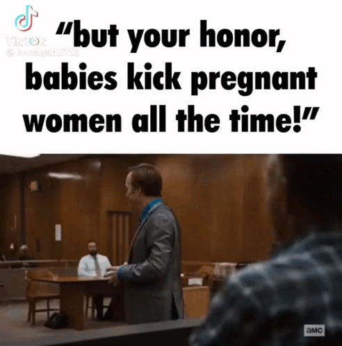Man in Suit Talking to Woman in Courtroom