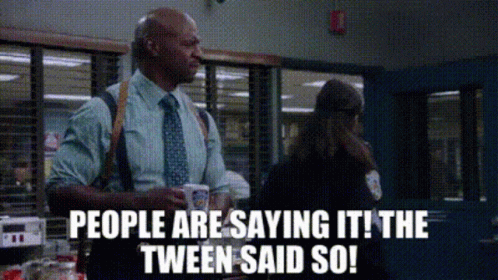 Man in Suit Talking to Woman in Police Station Holding Coffee
