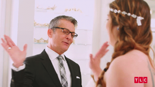 Man In Suit Talking To Woman In Wedding Dress TLC Logo GIF