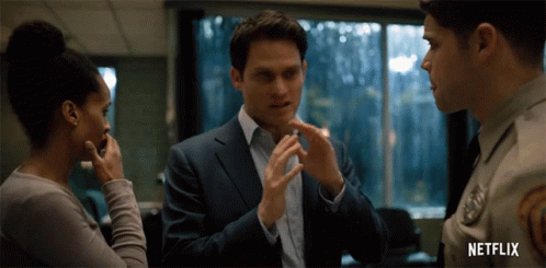 Man in Suit Talks to Woman and Police Officer Netflix