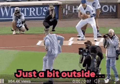 Man In Suit Throwing Baseball Just Outside GIF
