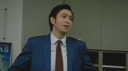 Man In Suit Thumbs Up In Front Of Reach The As Sign GIF