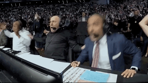 Man In Suit Tie At Desk Before Crowd GIF