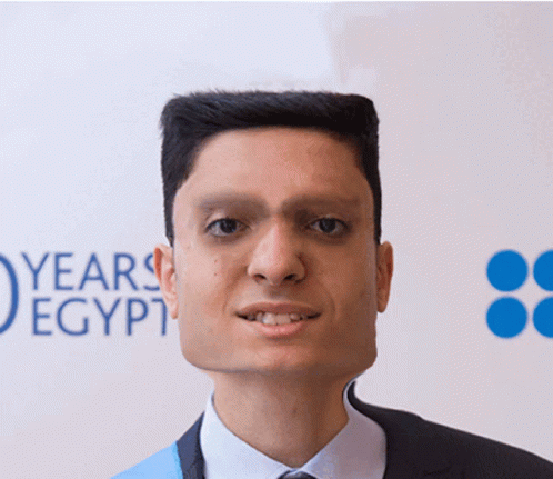 Man in Suit Tie Facing Years Egypt Sign