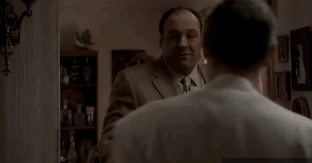 Man in Suit Touching Another's Neck