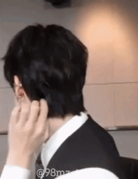 Man In Suit Touching Ear GIF