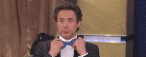Man in Suit Tying Bow Tie