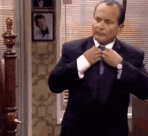 Man in Suit Tying His Tie