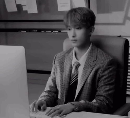 Man in Suit Typing on Keyboard