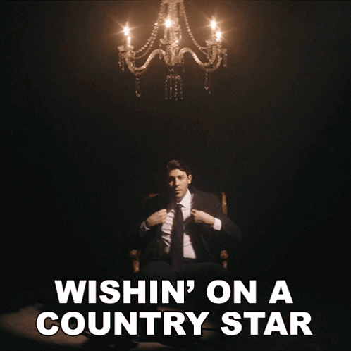 Man in Suit Under Chandelier Wishing Country Star