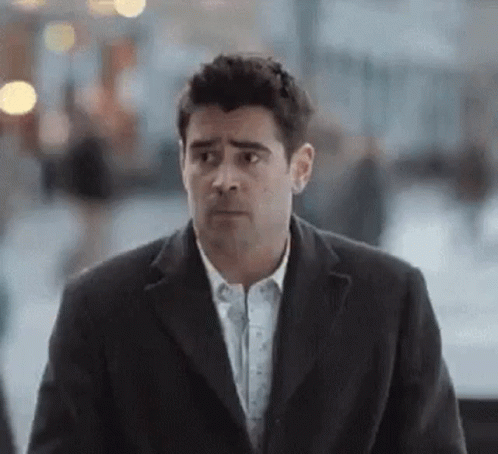 Man In Suit Walking And Looking At Camera GIF