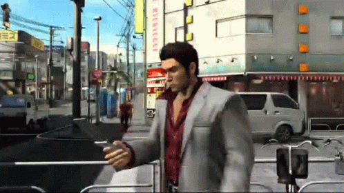 Man In Suit Walking And Looking At Phone GIF