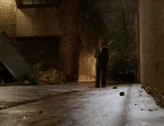 Man in Suit Walking Down Dark Alley