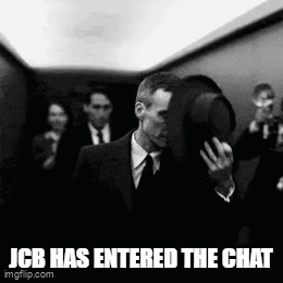 Man in Suit Walking Down Elevator Holding Hat