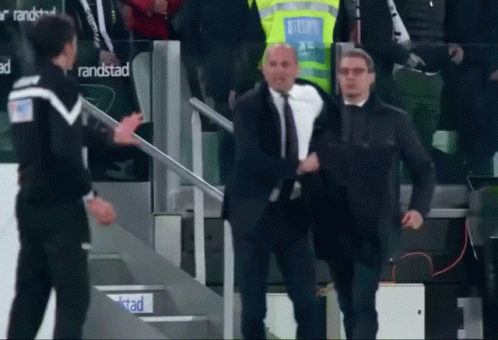 Man In Suit Walking Down Stairs In Front Of Randstad Sign GIF