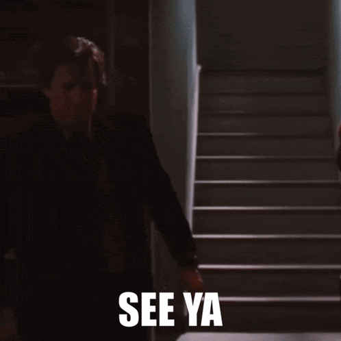 Man in Suit Walking Down Stairs Saying See Ya
