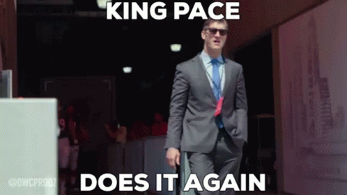 Man in Suit Walking Hallway Saying King Pace Does It Again