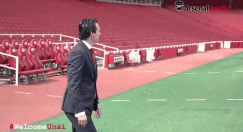 Man in Suit Walking on Soccer Field Welcome Unai