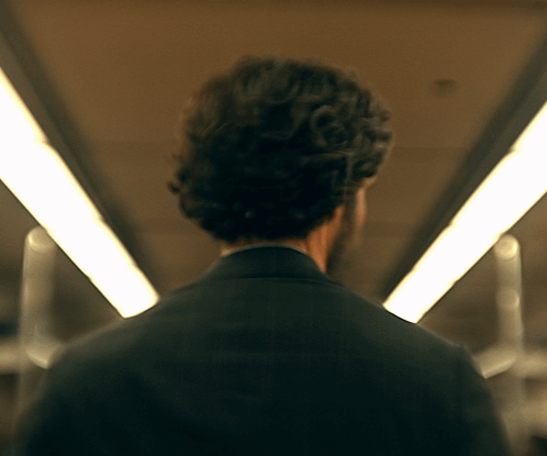 Man in Suit Walking Tunnel