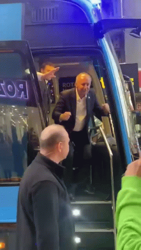 Man in Suit Walking Up Bus Stairs With Rot