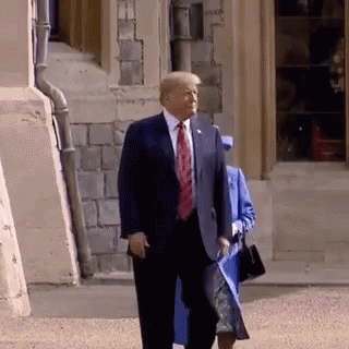 Man in Suit Walking With Woman in Blue Coat