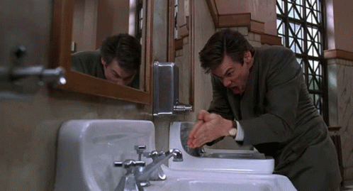 Man in Suit Washing Hands